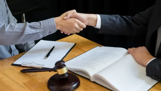 business-handshake-with-gavel-and-legal-documents-2026-01-08-22-27-01-utc