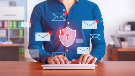 man typing with data breach signals