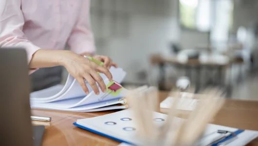 businesswoman-hands-working-in-stacks-of-paper-fil-2024-12-07-02-20-11-utc
