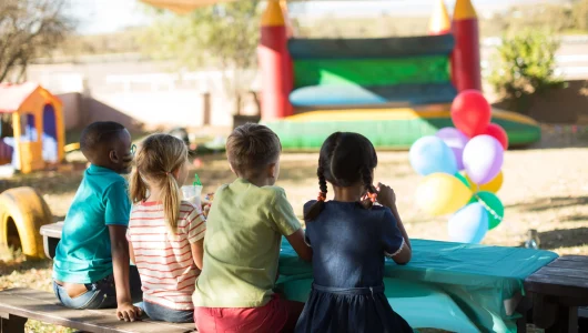 children-sitting-on-bench-at-park-2025-04-03-07-00-44-utc
