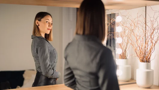 confident-woman-looking-to-her-reflection-into-the-2023-11-27-05-08-53-utc