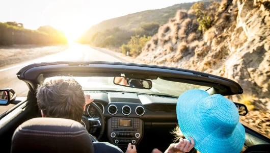 couple-on-convertible-car-2025-03-14-21-12-57-utc