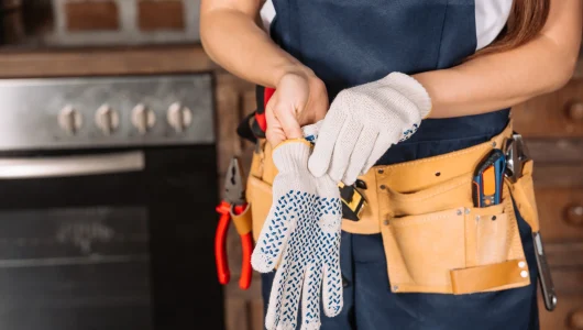 cropped-shot-of-repairwoman-putting-on-work-gloves-2026-01-06-00-36-28-utc