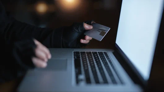 hacker-using-laptop-computer-stealing-credit-card-2026-03-25-07-23-27-utc
