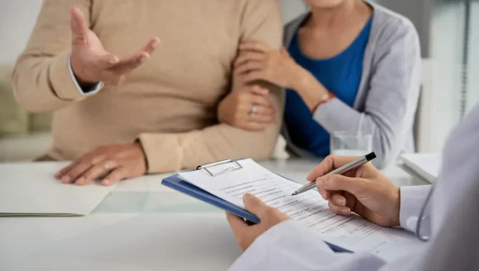 mature-couple-discussing-health-concerns-with-doct-2026-03-18-14-55-03-utc